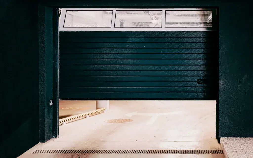 Modern garage door open at dusk, viewed from inside a DFW garage